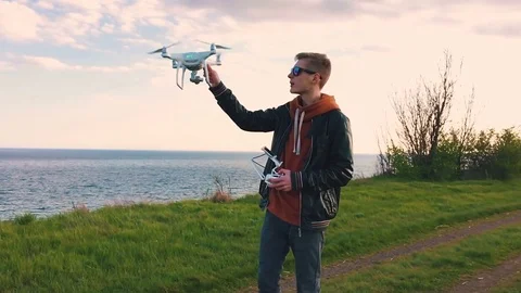 Quadrocopter lands on the pilot's hand. The pilot catches the drone. Slow motion Stock Footage 74794863