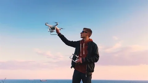 Quadrocopter lands on the pilot's hand. The pilot catches the drone. Slow motion Stock Footage 74795534