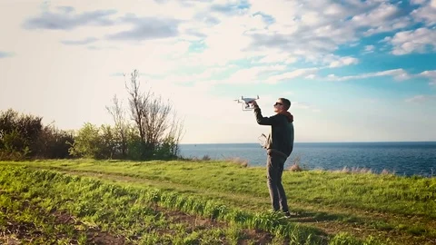 Quadrocopter lands on the pilot's hand. The pilot catches the drone. Slow motion Stock Footage 74795631