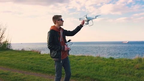 Quadrocopter lands on the pilot's hand. The pilot catches the drone. Slow motion Stock Footage 74795761