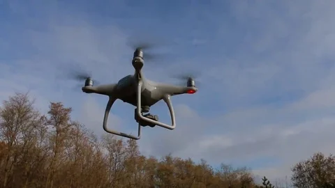Quadrocopter Phantom 4 drone flies over blue sky. Stock Footage 69123631