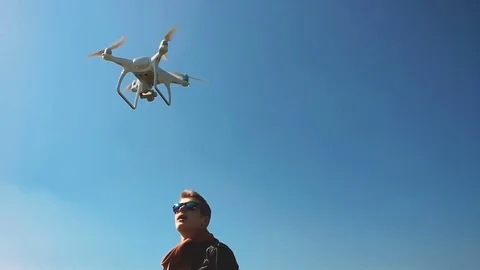 Quadrocopter takes off from the pilot's hand in slow motion. Running the Dron. Stock Footage 74411696