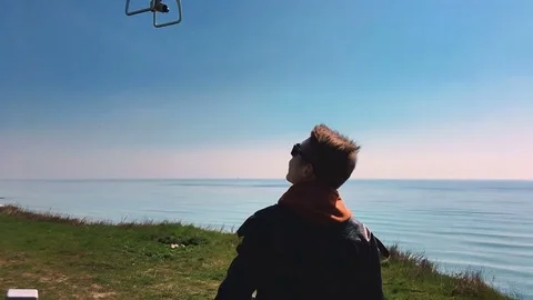 Quadrocopter takes off from the pilot's hand in slow motion. Running the Dron. Stock Footage 74412094
