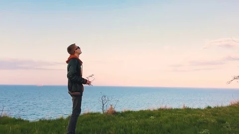 Quadrocopter takes off from the pilot's hand in slow motion. Running the Dron. Stock Footage 74798155