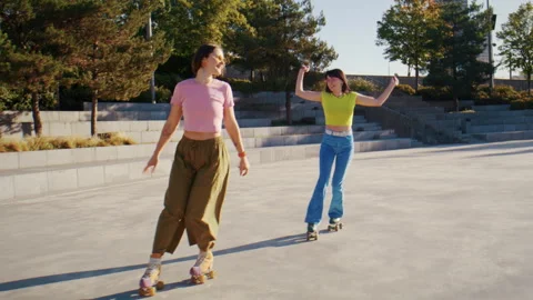 Quads skater pair performs synchronized glide with precise steps Stock Footage 319000924