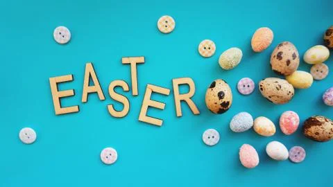 Quail Easter eggs on blue background. Flat lay, top view. Easter concept. Stock Photos