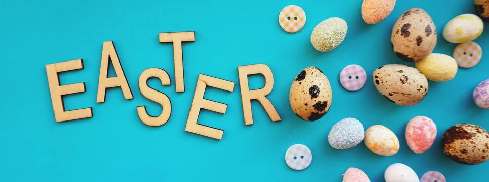 Quail Easter eggs on blue background. Flat lay, top view. Easter concept. Stock Photos