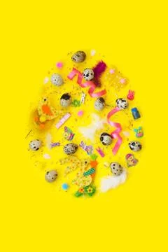 Quail eggs and decoration, in egg shape, on yellow background with copy space Foto stock