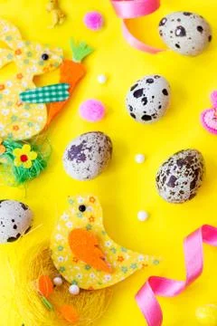 Quail eggs and easter decoration on yellow background with copy space; easter Foto stock