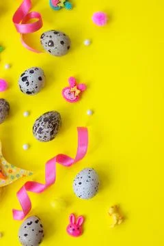 Quail eggs and easter decoration on yellow background with copy space; easter Foto stock