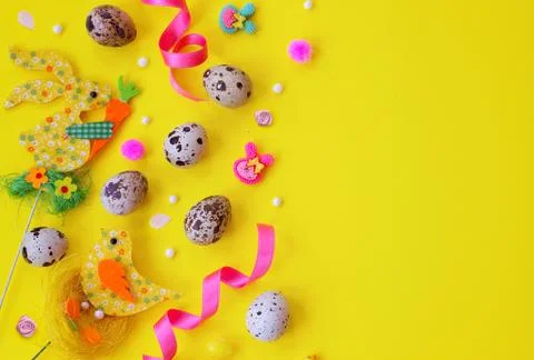 Quail eggs and easter decoration on yellow background with copy space; easter 库存照片