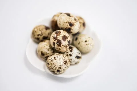 Quail eggs in bowl isolated on white background Stock Photos