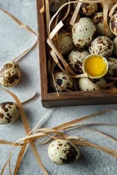 Quail eggs. Flat lay composition with small quail eggs in the wooden box on t Stock Photos