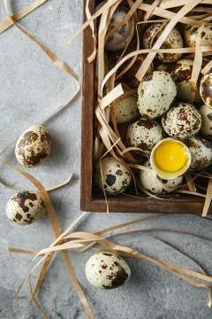 Quail eggs. Flat lay composition with small quail eggs in the wooden box on t Stock Photos