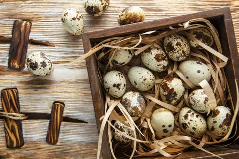 Quail eggs. Flat lay composition with small quail eggs in the wooden box on t Stock Photos