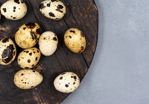 Quail eggs on a gray background. Proper nutrition. Diet food Stock Photos
