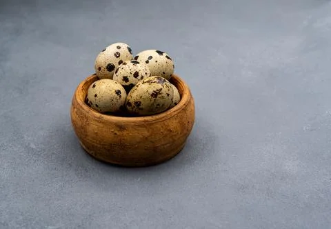 Quail eggs on a gray background. Proper nutrition. Diet food Stock Photos