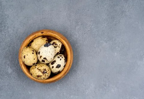 Quail eggs on a gray background. Proper nutrition. Diet food Stock Photos