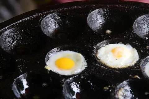 Quail eggs grilling on pan. Stock Photos