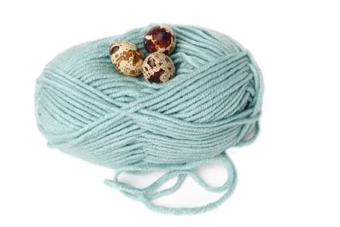 Quail eggs in a nest of thread Stock Photos