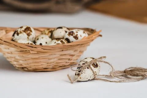 Quail eggs on table and wicker basket, selective focus Stock Photos