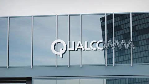 QUALCOMM Stock data presented on the logo of the office facade editorial Stock Photos
