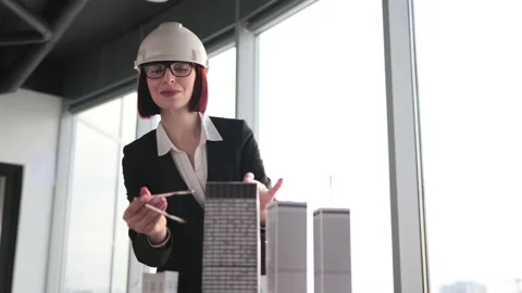Qualified female architect, engineer in suit and hard hat measuring skyscraper Stock Footage 234220470