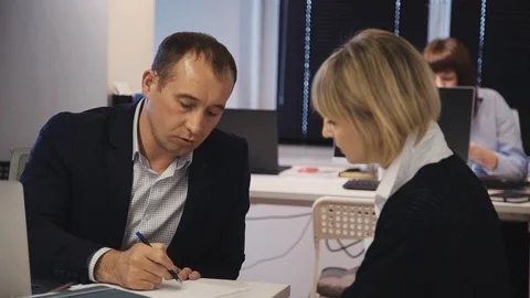 Qualified man making notes and researching new startup with woma Stock Footage 115198892