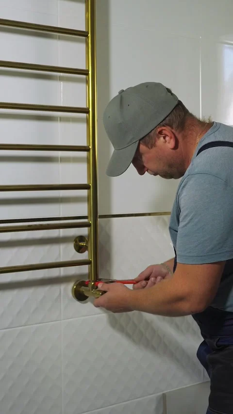 A qualified plumber uses a wrench. Interior construction work in a house. A Video stock 324046903