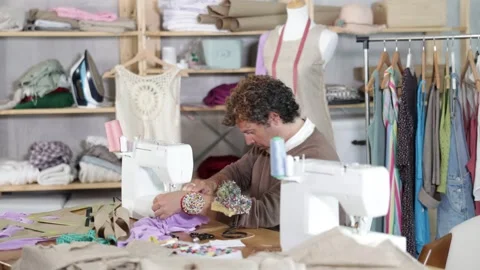 Qualified tailor sews custom-made clothes in the workshop Stock Footage 344844200