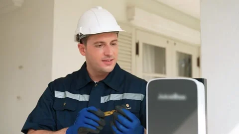 Qualified technician install home EV charging station. Fastidious Stock Footage 262108739