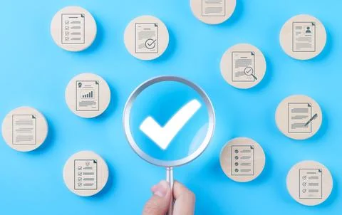 Quality assurance document control concept. Magnifying glass focus on check Stock-Fotos