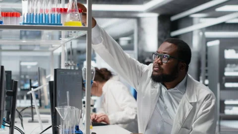 Quality control analyst in lab testing blood sample using computer Stock Footage 320729876
