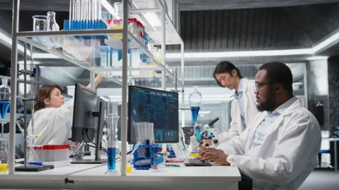 Quality control analyst in laboratory analyzing solution at workstation using PC Stock Footage 320741755