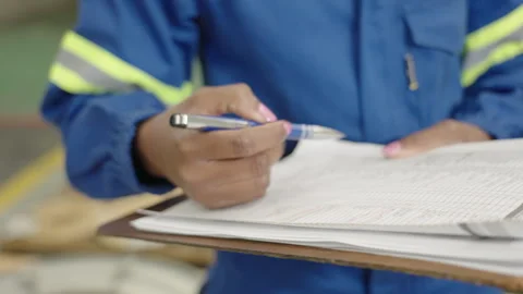 Quality Control Checklist in Blue Safety Coveralls at Steel Foundry Video stock 345002518