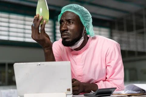 Quality control engineer. Workers in the factory write down notes about bottl Stock Photos