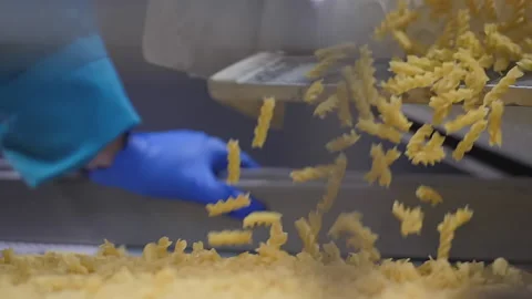 Quality control manager working at the pasta factory checks macaroni quality Stock Footage 163394450