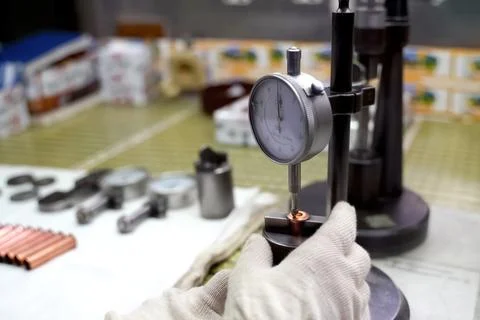 Quality control operator checks the chuck parts for compliance with the dim.. Stock Photos