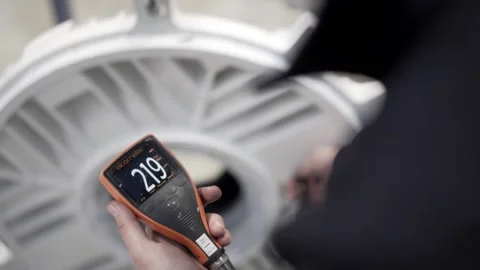Quality control specialist measures the paint thickness on the product Stock Footage 146838524