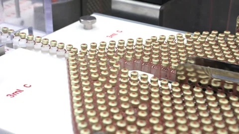 Quality Control vials for injection. Individual checks vial under a microscope.  Stock Footage 127569000