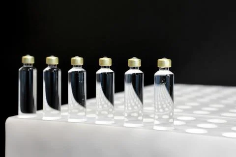 Quality Control vials for injection. Individual checks vial under a microscop Stock Photos