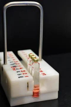 Quality Control vials for injection. Individual checks vial under a microscop Stock Photos