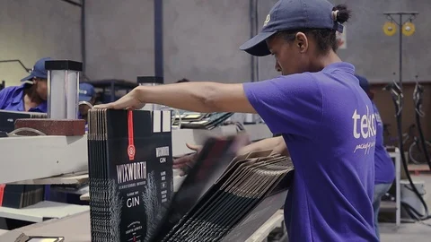 A quality controller inspects custom branded cardboard boxes in a South Stock Footage 105325855