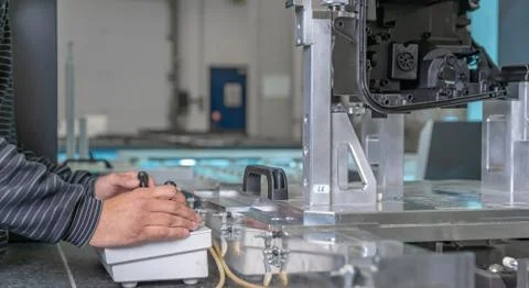 Quality engineer controls an instrument for 3D measurement of plastic castings 스톡 사진