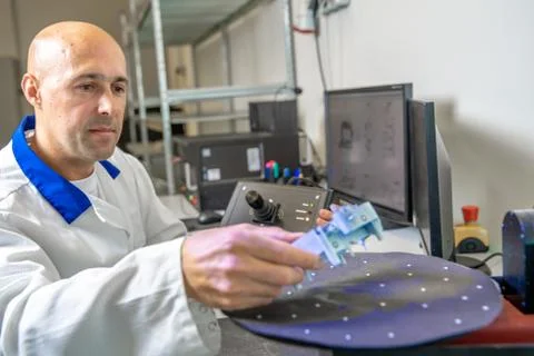 Quality engineer examines a sample scanned with a laser on a 3d scan in a Stock Photos