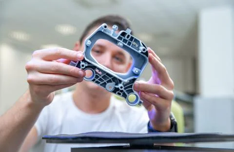 Quality engineer examines a sample scanned with a laser on a 3d scan in a Stock Photos