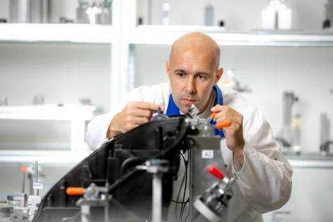 Quality engineer measuring plastic components by digital meter on the fixture Photos