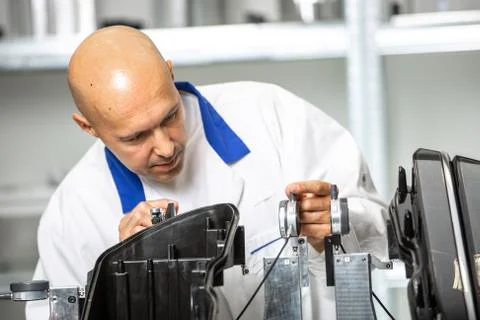 Quality engineer measuring plastic components by digital meter on the fixture Stock Photos