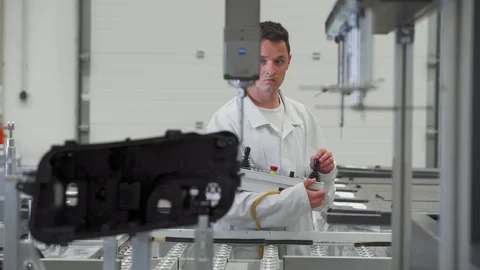 Quality engineer programs a machine for 3D measurement of plastic casting in the Stock Footage 129839459