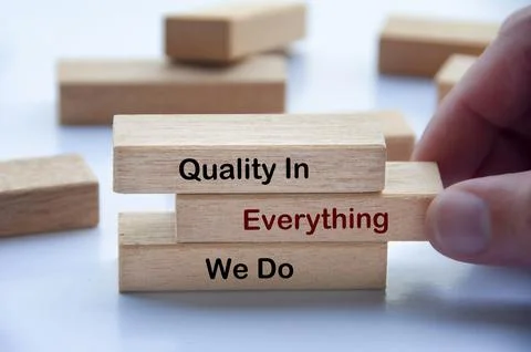 Quality In Everything We Do text on wooden blocks emphasizing commitment to.. Stock Photos